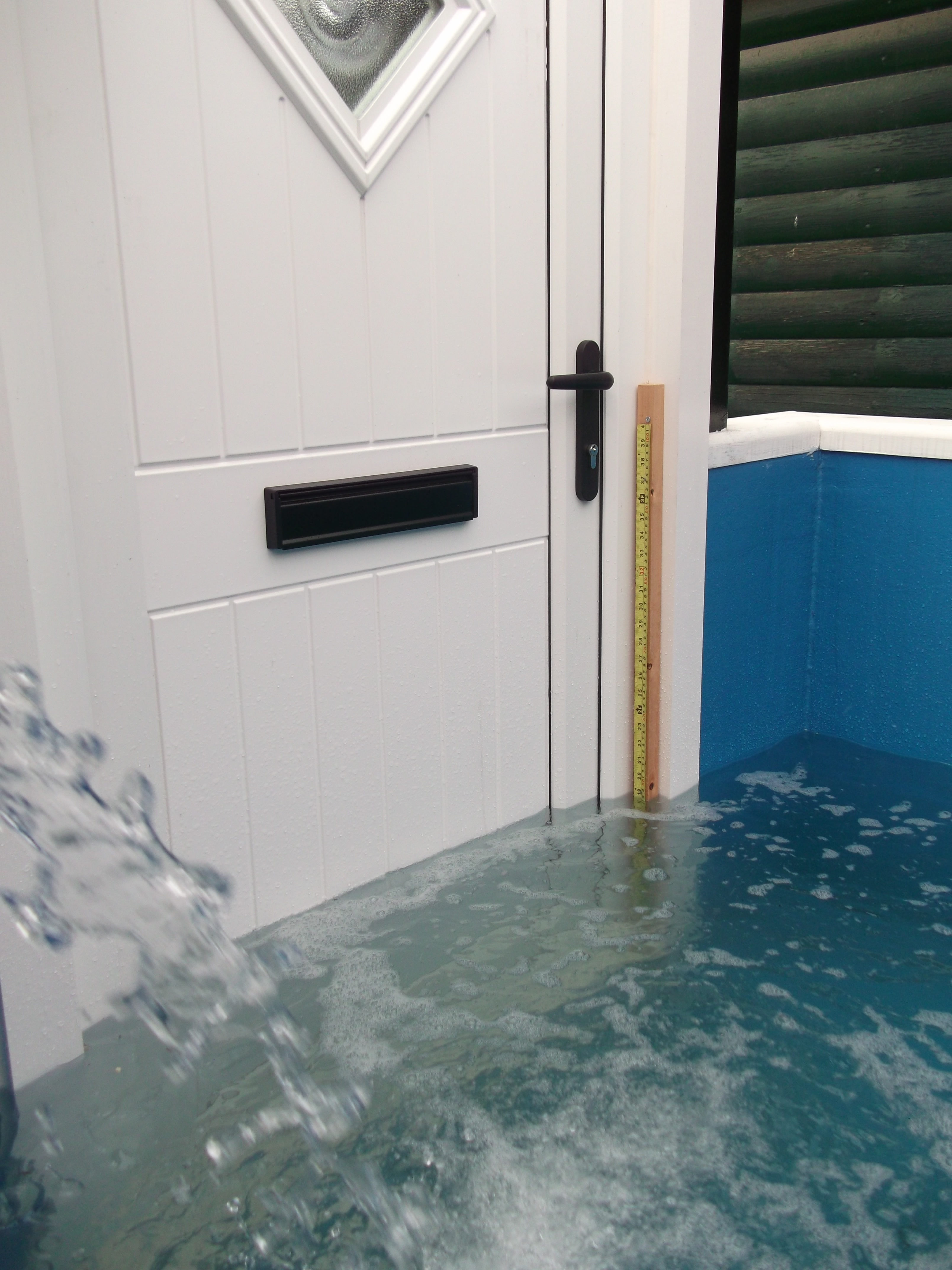 Flood Door Extreme Testing in Simulated Flood Conditions. StormMeister Flood Doors are available in white, Wood Grains, or  a range of Door Colour Options